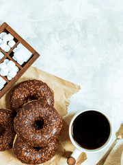 Chocolate donuts and coffee , weekend morning table breakfast. Vintage colors.