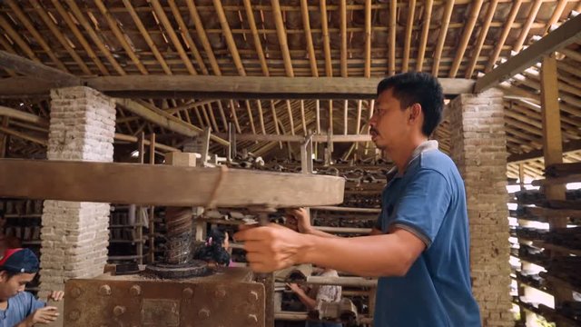 Men and women working at manual clay roof tiles making factory in Kebumen, Indonesia