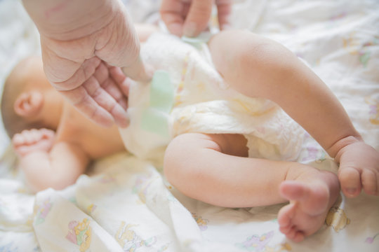 close-up of hands wearing baby diapers
