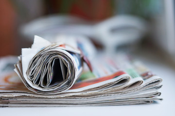 Pile of newspapers. Folded and rolled papers with news, selective focus