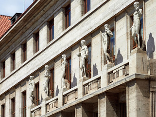 Fototapeta na wymiar PRAGUE, CZECH REPUBLIC - MAY 16, 2017: Stone nude sculptures on the exterior of the Municiple Library in the centre of Prague.