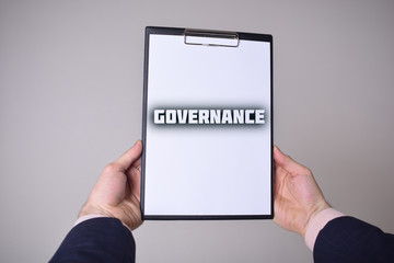 A businessman shows an inscription:GOVERNANCE