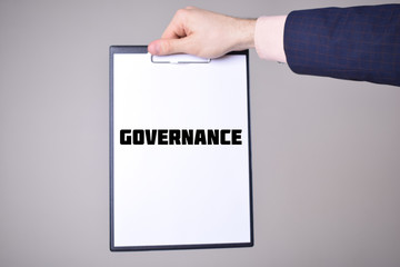 A businessman shows an inscription:GOVERNANCE