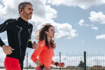 young adults couple running together