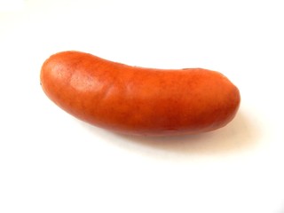 Appetizing frankfurter on white background. Smoked sausage from beef. Weenie close-up. Photo of sausage, red-hot or snag.