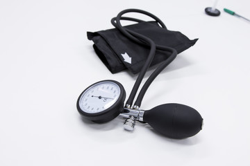 Sphygmomanometer or  blood-pressure cuff on a white background