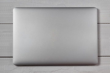 White laptop on wooden table