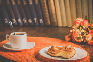 A cup of coffee and a plate with pastries