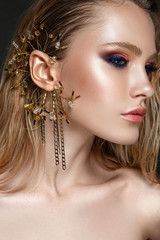 Beautiful woman portrait profile with jewelry on ear.