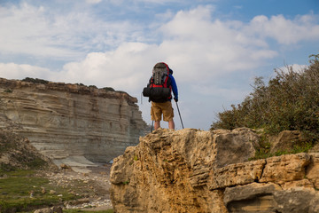 campaign with a backpack on with a tent
