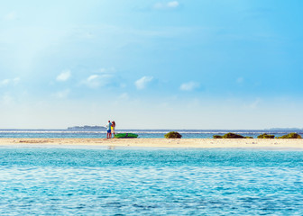 Couple in love on the shore of the Indian ocean, Male, Maldives. Copy space for text.