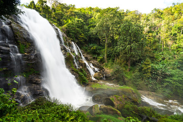 scene of side of giant waterfall in forest