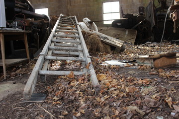 Old wooden ladder in abandoned farm building