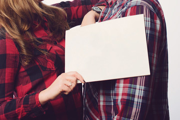 Couple in Plaid Shirts with Paper