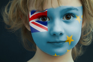 Portrait of a child with a painted Tuvaluan flag