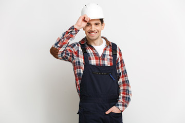 Smiling male builder in protective helmet looking at the camera