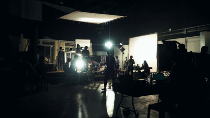 Silhouette of people working in big production studio
