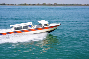 Daylight panning view to ambulance boat cruising on water © frimufilms