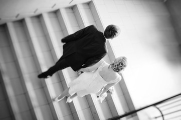  loving couple rises up the stairs, a view from behind, a black-and-white image
