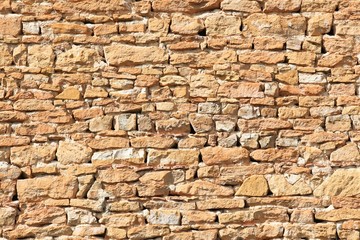 Background of orange stone wall texture in Beaujolais, France