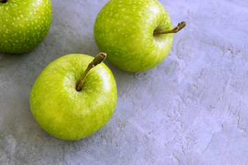 Fresh green apples on the table, close up.