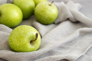 Fresh green apples on the table, close up.