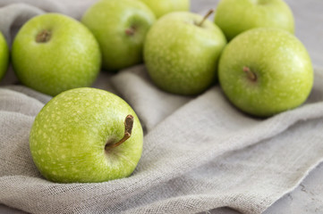 Fresh green apples on the table, close up.