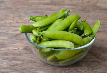 Fresh Green peas. Top view. Pea on wooden background
