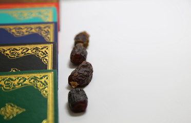 Three months.Islamic Holy Book Quran under soft light on White Background. Ramadan concept . The Koran with rosary beads and date.