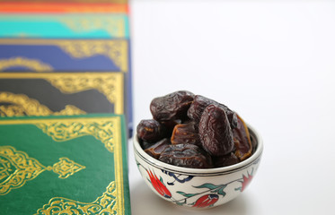 Three months.Islamic Holy Book Quran under soft light on White Background. Ramadan concept . The Koran with rosary beads and date.