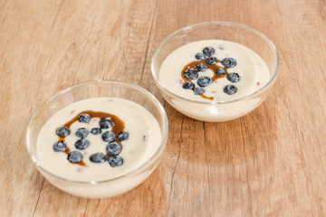 Vanilla pudding with blueberries and toffee sauce. - 198473901