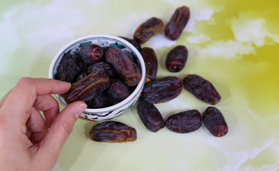 Three months.Islamic Holy Book Quran under soft light on White Background. Ramadan concept . The Koran with rosary beads and date.