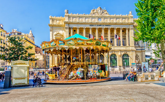 One of Marseille square with a merry-go-round and the "Palais de la Bourse" building in spring 2017