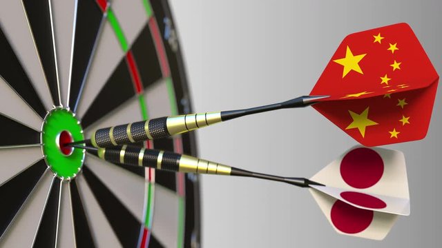 Flags of China and Japan on darts hitting bullseye of the target. International cooperation or competition conceptual animation