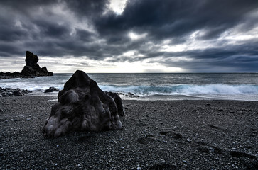 Amazing rock formations made by erstwhile flowing lava on a black sand beach in Iceland - Powered by Adobe