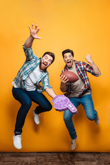 Portrait of a two happy young men jumping