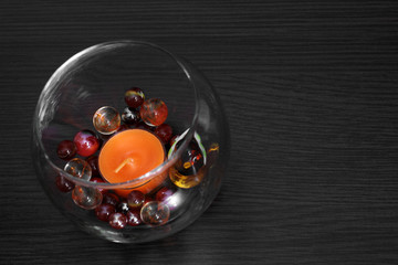 Candle in glass vase with glass balls