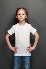 Kid girl wearing white t-shirt with space for your logo or design in casual urban style