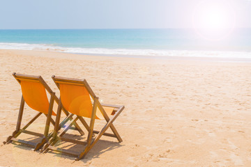 Beach chairs on the sandy beach of the ocean.