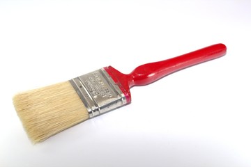 Paint brush width 2 inches with a red handle on a white background close-up