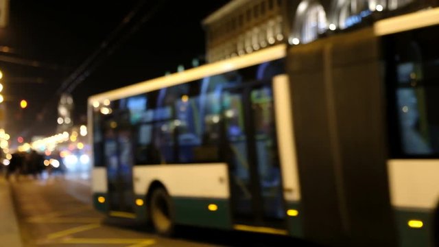 Blurred bus on the street at night.