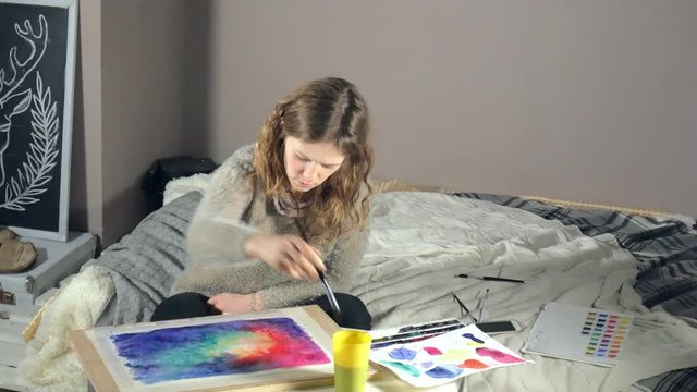 Adult women paint with colored watercolor paints in an art school close up