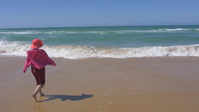 woman walking to beach, slow motion