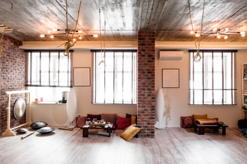 Loft room for fitness and relaxation, relaxation with brick walls and windows, gym, tea.