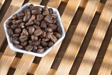 Roasted coffee on the wooden background - Coffee