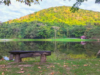 wood bench fornt of lake and mountain