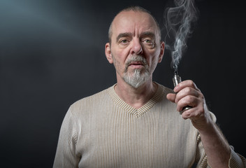 portrait of a man with beard who is vaping