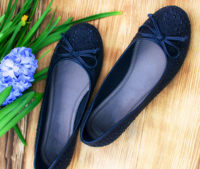black suede female ballet flats on a wooden background © Hanna