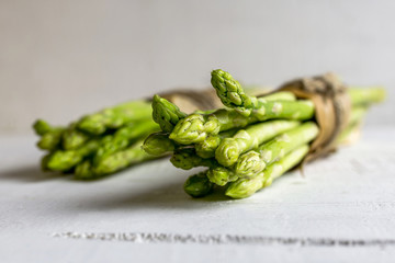 Fresh green asparagus on wooden background