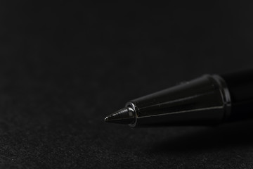 Close up silver pen and black book